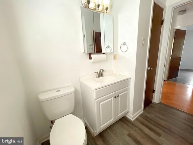 bathroom featuring hardwood / wood-style floors, vanity, and toilet