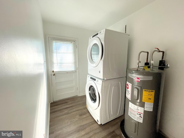 clothes washing area with wood-type flooring, stacked washer / drying machine, and water heater