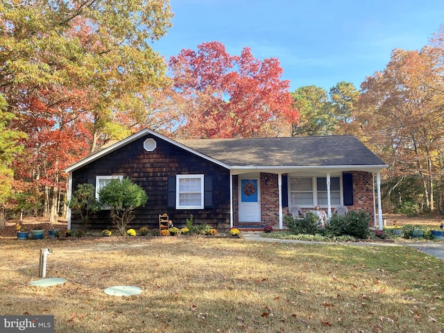 ranch-style house with a porch and a front yard