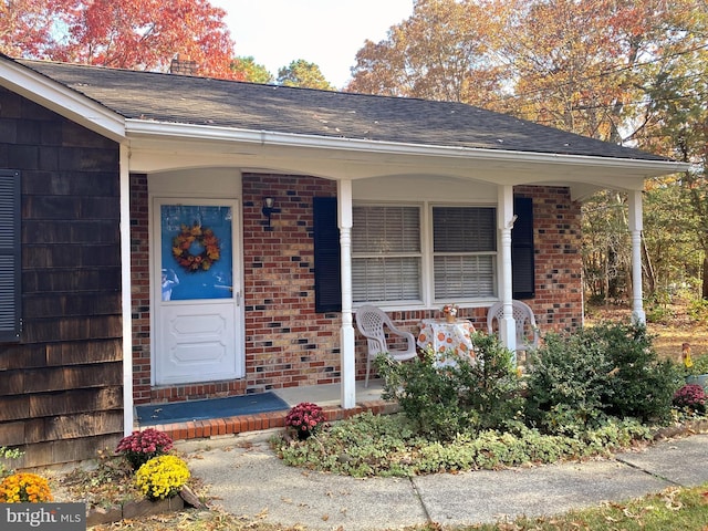 view of exterior entry with covered porch