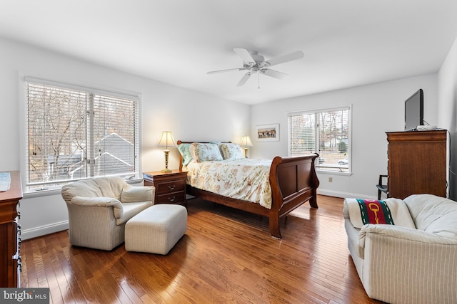 bedroom featuring a ceiling fan, wood-type flooring, and baseboards