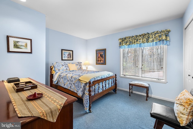 bedroom with a closet, carpet flooring, and baseboards