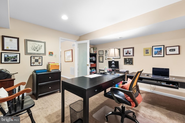 office featuring light carpet, visible vents, and baseboards