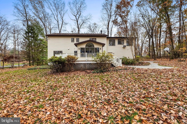 back of property with a wooden deck