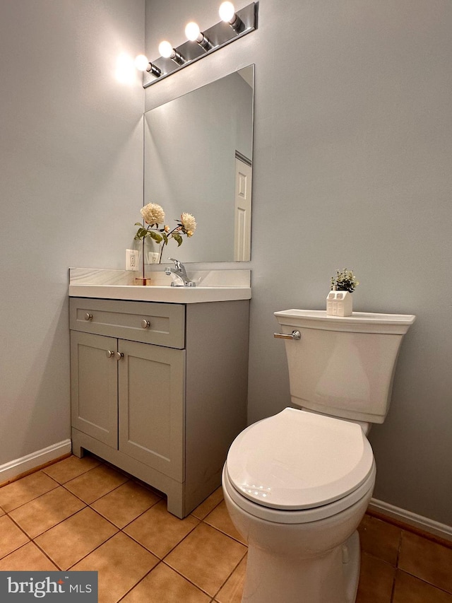 bathroom with tile patterned flooring, vanity, and toilet