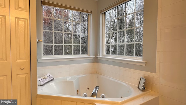 bathroom with a relaxing tiled tub