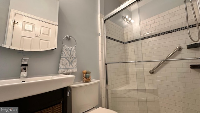 bathroom with walk in shower, vanity, and toilet