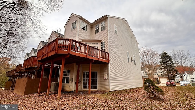 back of property with a deck and central AC unit