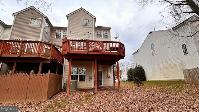 back of house with central air condition unit and a wooden deck