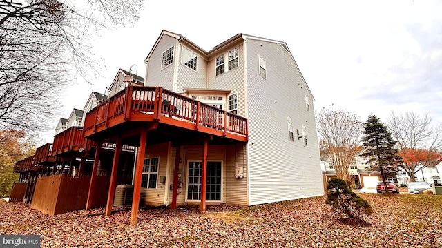 rear view of property featuring central AC and a deck