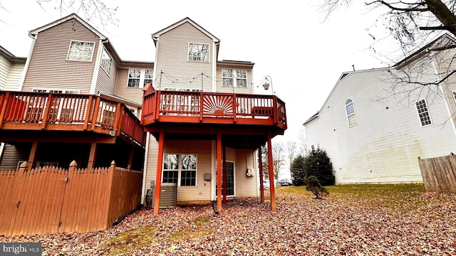 back of house with a deck and central AC unit