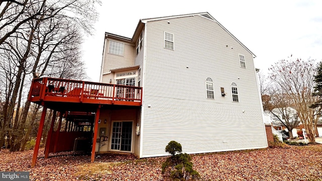 rear view of house with a wooden deck