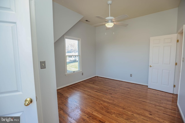 interior space featuring dark hardwood / wood-style flooring, vaulted ceiling, and ceiling fan