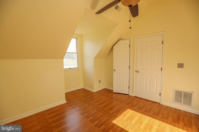 bonus room with wood-type flooring, ceiling fan, and lofted ceiling