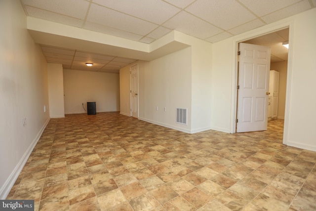 basement featuring a paneled ceiling