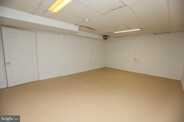 basement with a paneled ceiling