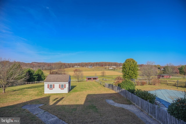 view of yard with a rural view and an outbuilding