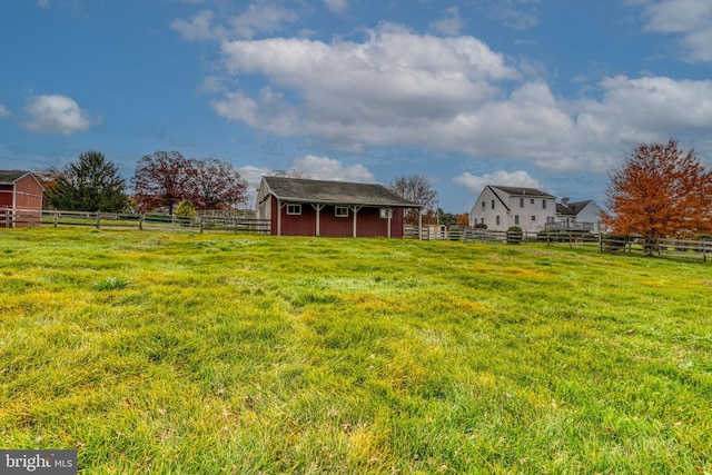 view of yard featuring a rural view and an outdoor structure