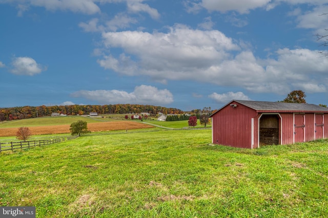 view of yard with a rural view and an outbuilding