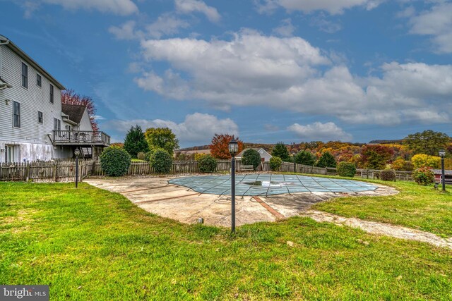 view of swimming pool featuring a lawn and a patio area