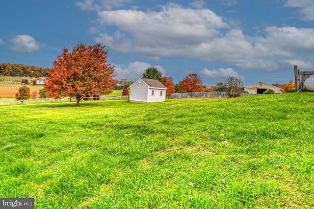 view of yard with a rural view and a shed