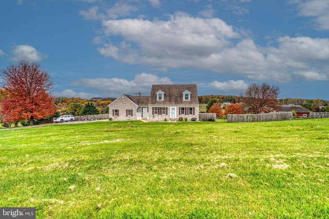 cape cod house featuring a front lawn