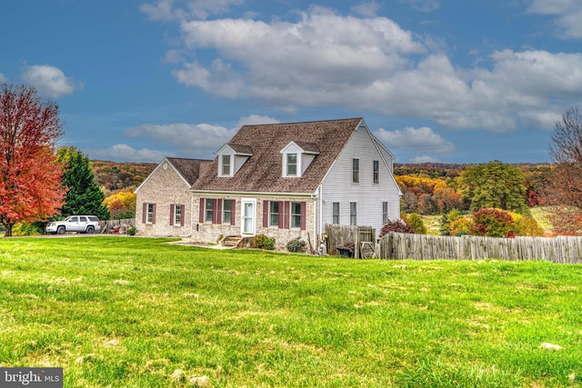 cape cod house with a front yard