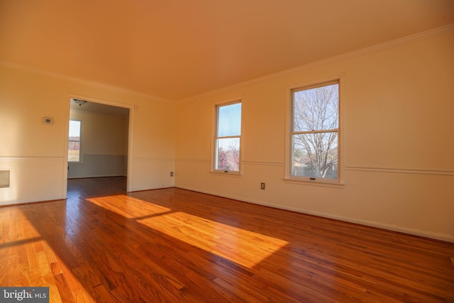 empty room featuring hardwood / wood-style floors and ornamental molding