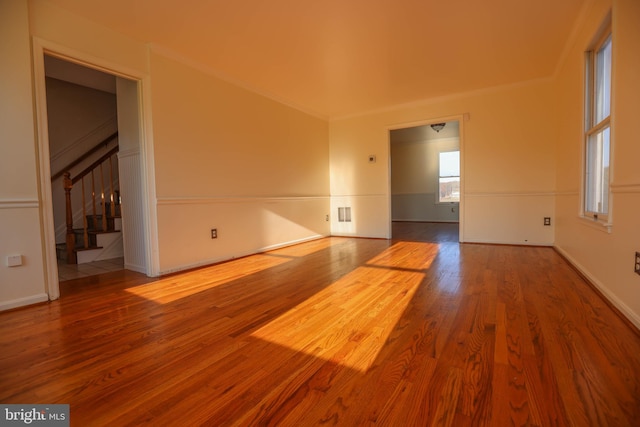 spare room with ornamental molding and hardwood / wood-style flooring