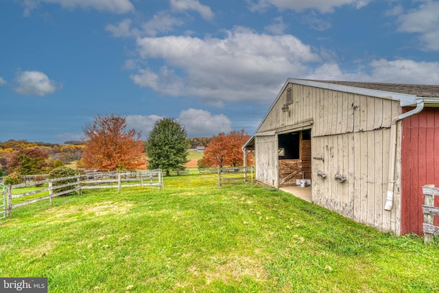 view of yard with an outbuilding and a rural view