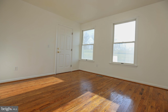 spare room with hardwood / wood-style floors