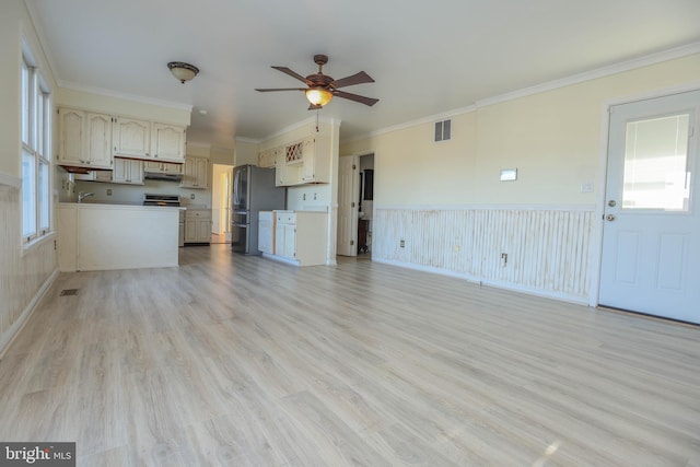 unfurnished living room featuring ceiling fan, light wood-type flooring, and ornamental molding