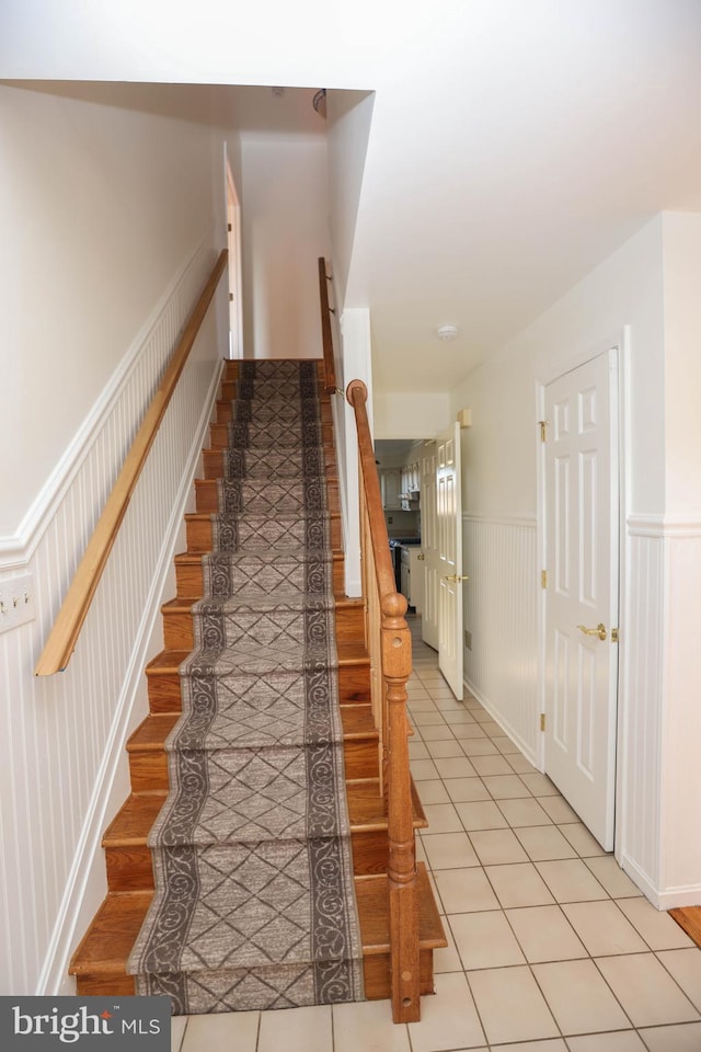 stairway featuring tile patterned floors