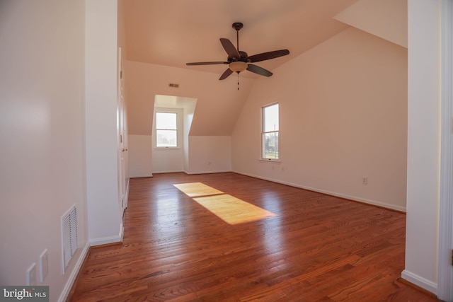 bonus room with ceiling fan, dark wood-type flooring, and vaulted ceiling