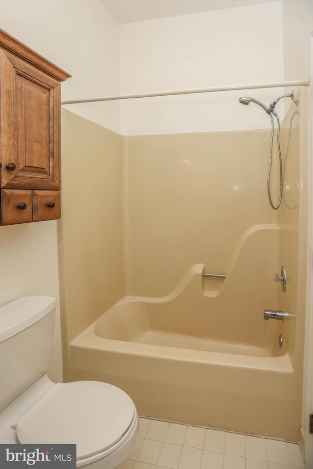 bathroom with tile patterned flooring, toilet, and shower / bath combination