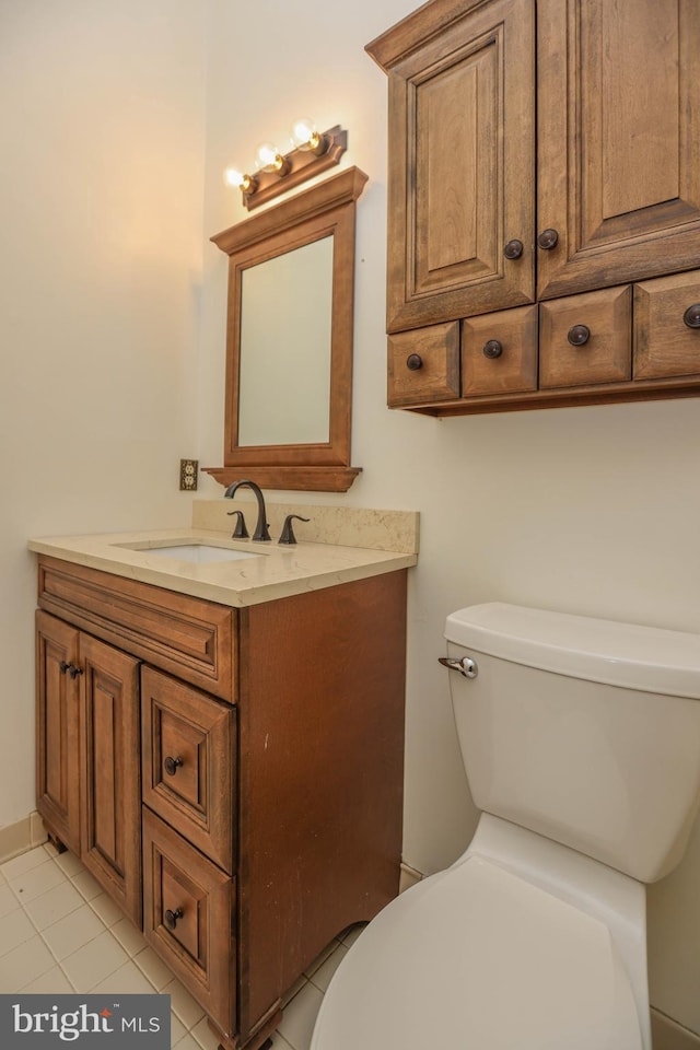 bathroom with tile patterned floors, vanity, and toilet