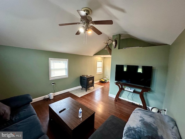 living room with a wood stove, lofted ceiling, ceiling fan, and dark hardwood / wood-style floors