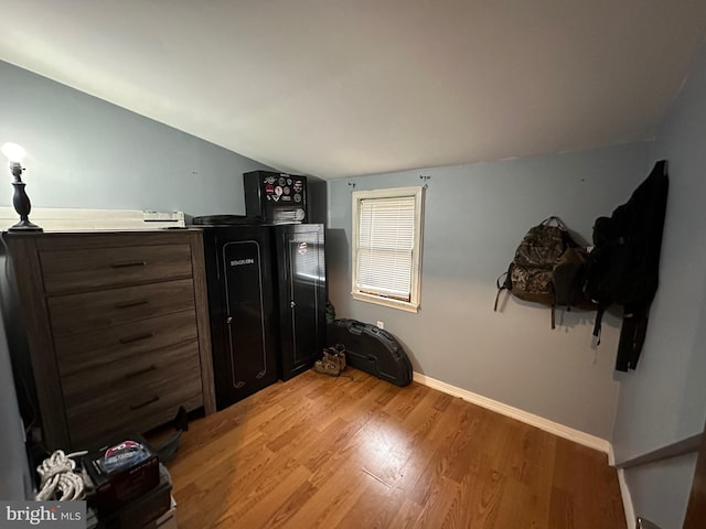 bedroom featuring light hardwood / wood-style flooring and vaulted ceiling