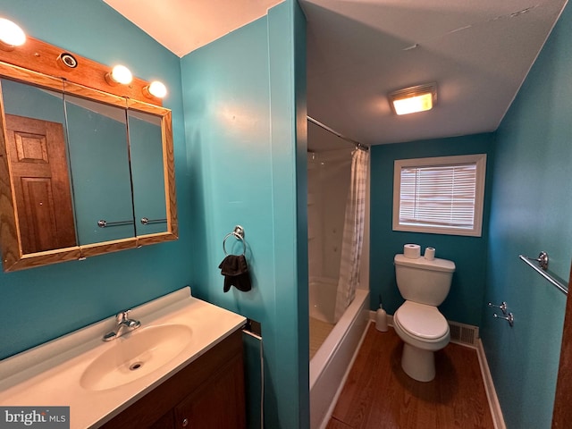 full bathroom with hardwood / wood-style flooring, vanity, toilet, and shower / tub combo with curtain