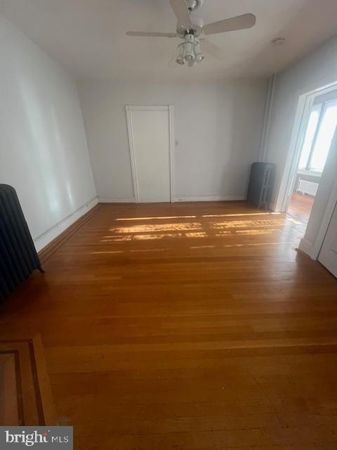 spare room featuring hardwood / wood-style flooring and ceiling fan