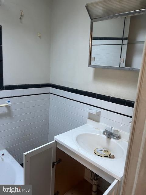 bathroom with tile walls