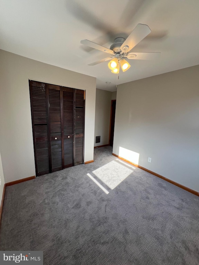 unfurnished bedroom featuring ceiling fan, a closet, and carpet floors