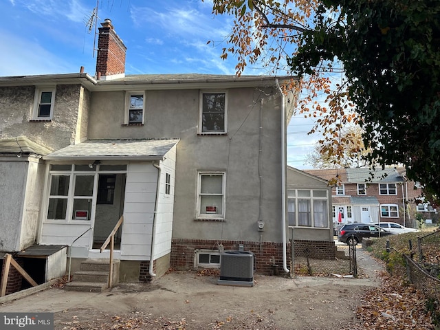 back of property featuring central AC