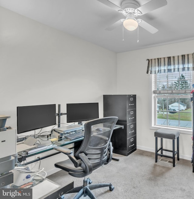 carpeted office space with ceiling fan