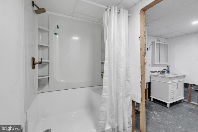 bathroom with a paneled ceiling, vanity, and concrete floors