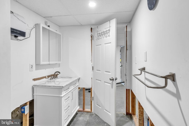 bathroom featuring a paneled ceiling, vanity, and concrete floors