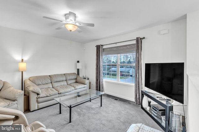 carpeted living room with ceiling fan