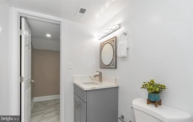 bathroom featuring vanity and toilet