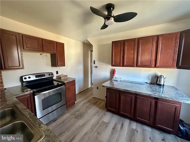 kitchen featuring electric range, sink, ceiling fan, and light wood-type flooring