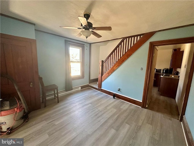 interior space with ceiling fan and light wood-type flooring